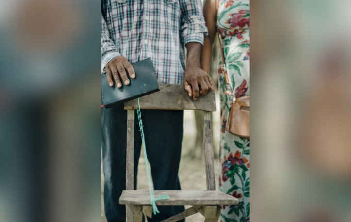 man and woman holding hands with a bible