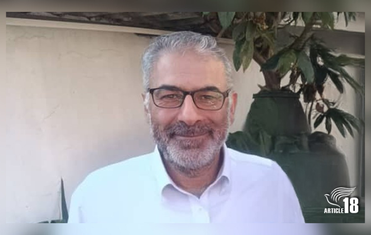 Smiling Iranian pastor in white shirt