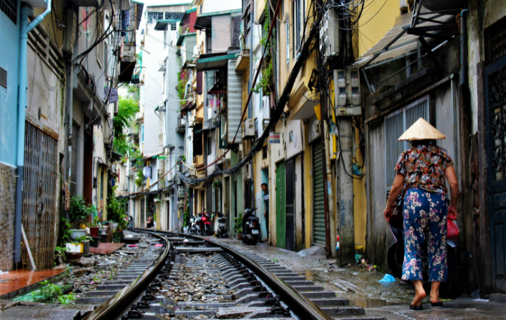 Woman walking by the train track in Vietnam